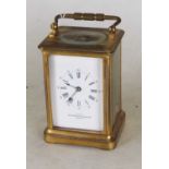 An early 20th century lacquered brass cased carriage clock, the enamelled dial with Roman numerals