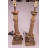 A pair of early 19th century style gilt and beige painted table lamps, each in the form of a Doric