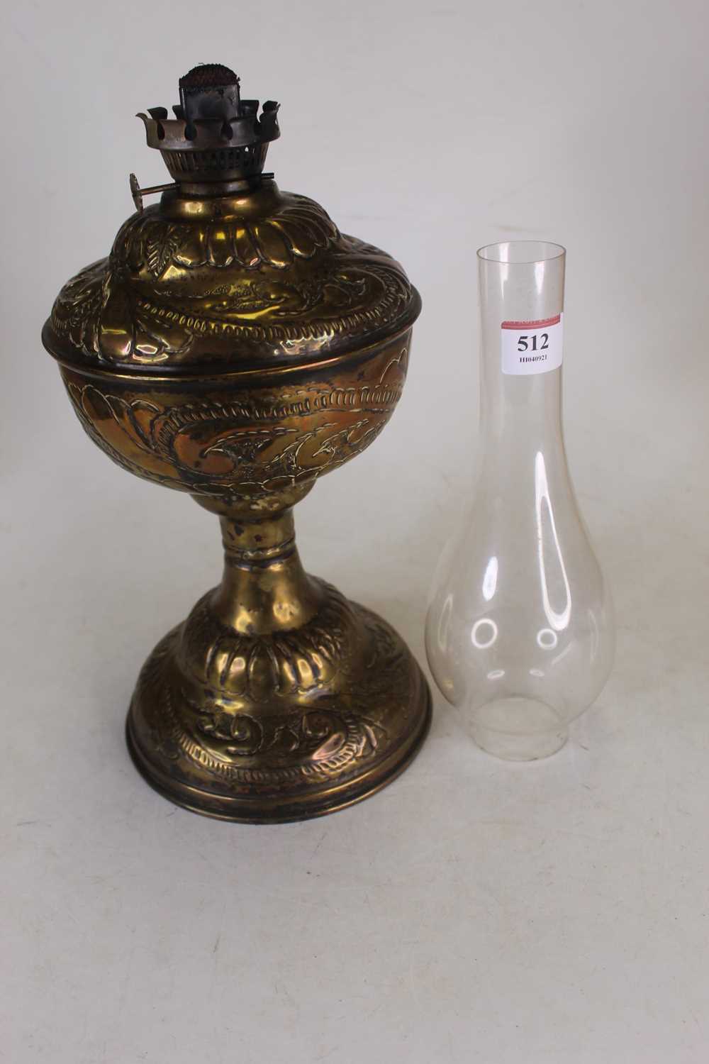 An Art Nouveau influenced embossed brass floral decorated oil lamp, with glass chimney, height 53. - Image 2 of 3