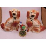 A pair of 20th century Staffordshire style pottery models of seated spaniels, h.34cm; together