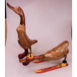 A carved bamboo model of a duck wearing red boots, h.50cm; together with one other similar wearing