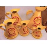 A set of five Shell Petroleum graduated oil measures, the largest h.33cm, the smallest h.18cm
