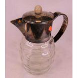 A silver plated and glass water pitcher, h.29cm