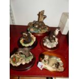 A Border Fine Arts resin model of two otters watching a crab, on wooden plinth, h.12cm; together