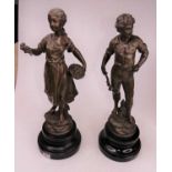 A pair of 19th century style spelter figures of a young couple, each mounted upon an ebonised