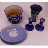 A small collection of Wedgwood blue jasperware, to include a pair of dwarf table candlesticks, vase,