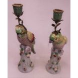 A pair of 20th century continental porcelain table candlesticks, in the Rococo taste, each in the