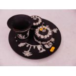 A small collection of Wedgwood Black Basalt wares, to include two plates, two trinket jars, and a