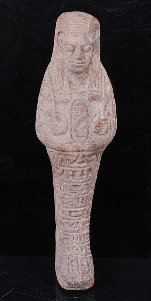 An Egyptian terracotta shabti, modelled in standing pose with impressed seal to the chest and