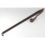 * A Continental military flail, the 88cm shaft with central studded iron core and oak mounts, the