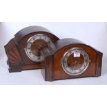 A 1950s oak cased mantel clock having a silvered dial with Arabic numerals and eight day movement,