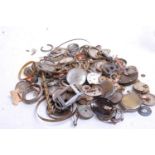 A collection of assorted wrist and pocket watch parts, to include dials, springs, case backs, part