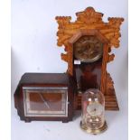 A late 19th century American oak cased gingerbread type clock having a circular gilt dial with Roman