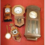 A 1930s oak cased wall clock; together with a droptrunk wall clock; and two others (4)