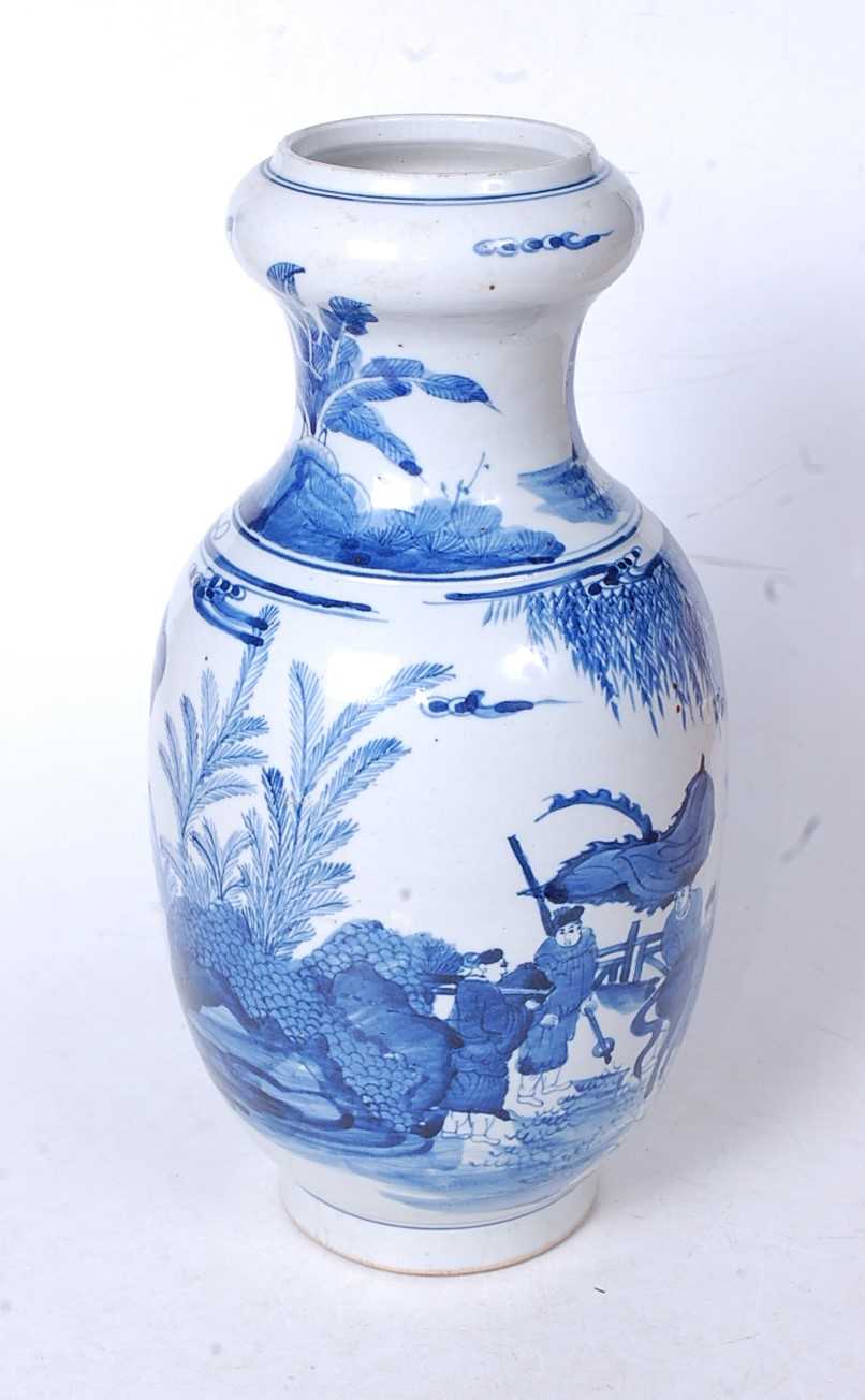 A Chinese export blue and white vase, having an onion top to a baluster body, underglaze blue