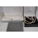A Pompadour faux pearl two string choker with marcasite set clasp, boxed, together with one other