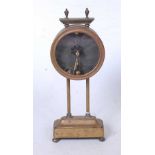 A late 19th century brass cased mystery clock, having a circular movement, on twin columns and