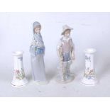 A Lladro Spanish porcelain figure of a boy with fishing rod and creel, having printed Lladro mark