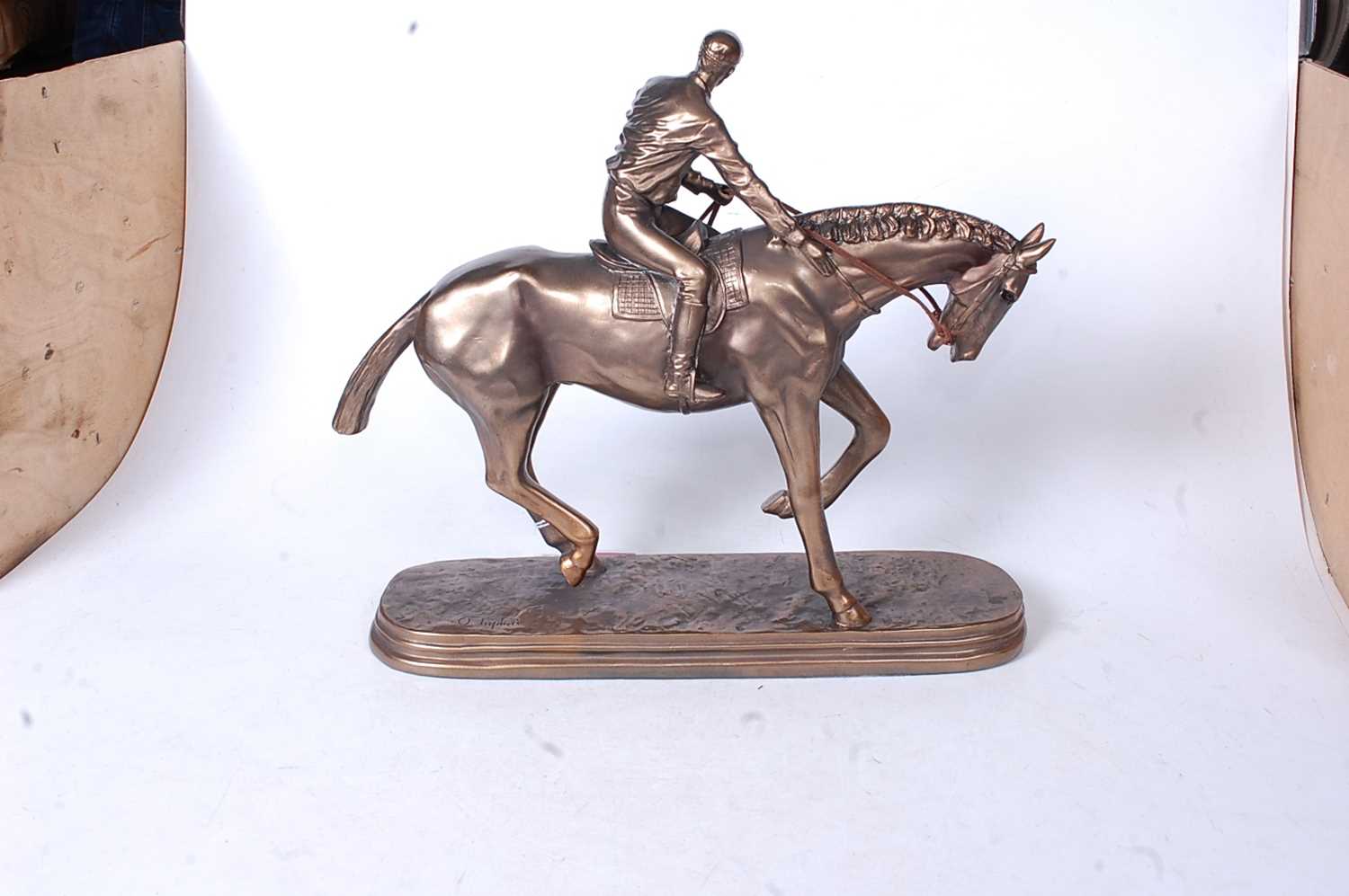 A reproduction bronzed resin figure of a racehorse and jockey, on naturalistic oval plinth, h.32cm - Image 3 of 3