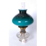 An early 20th century oil lamp, having a green opalescent glass shade, duplex burner and clear glass