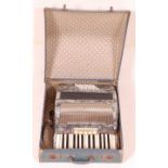 A German Alvari faux mother of pearl cased piano accordion no. K1217, in fitted leather case.