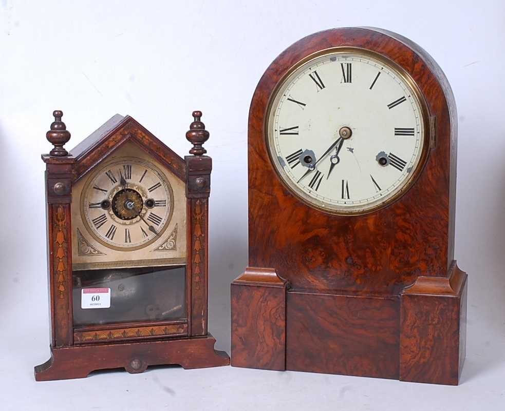 A Victorian walnut cased dome top mantel clock having a circular enamel dial with Roman numerals