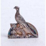 A 1960s silver menu holder, surmounted by a pheasant perched on a branch, 0.7oz