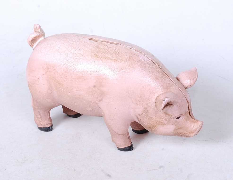 A reproduction cast metal money-box in the form of a pig