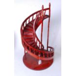 A modern stained ply model of a spiral staircase, h.60cm