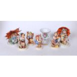 A collection of four Hummel figures, to include Appletree Boy, Feeding Time, Appletree Girl, and