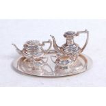 A modern silver miniature four piece tea service of half gadrooned oval form on matching oval