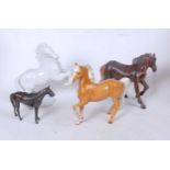 A Beswick porcelain Palamino, model No.1261, h.17cm; together with a carved hardwood model horse;