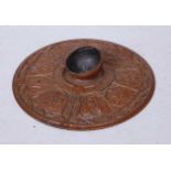 A mid-19th century bronze and copper circular inkwell, relief decorated with craftsmen and inscribed