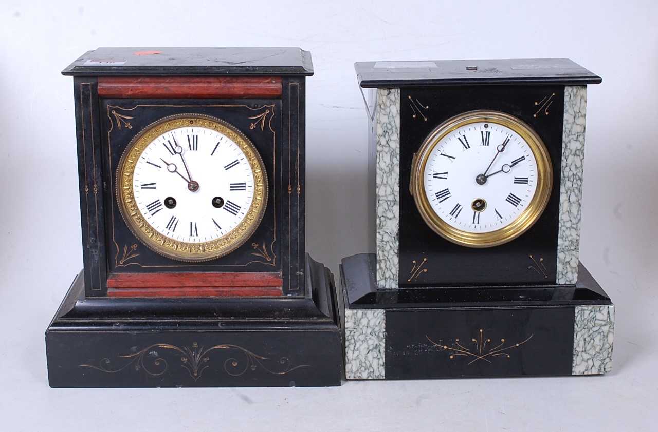 A late Victorian black slate and grey marble mantel clock having an enamel dial with Roman