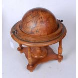 A reproduction paper-covered terrestrial globe on stand
