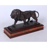 After Antoine Louis Bayre - a bronzed metal model of a lion in stalking pose, on a rectangular