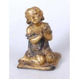 A 19th century gilt metal figure of a young girl in prayer, shown kneeling with hands raised upon