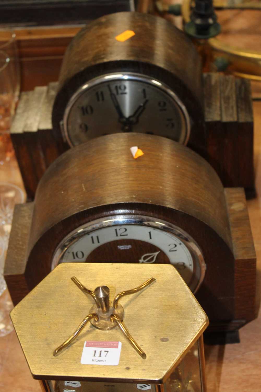 A Kundo brass cased anniversary type clock having a circular dial with raised Roman markers,