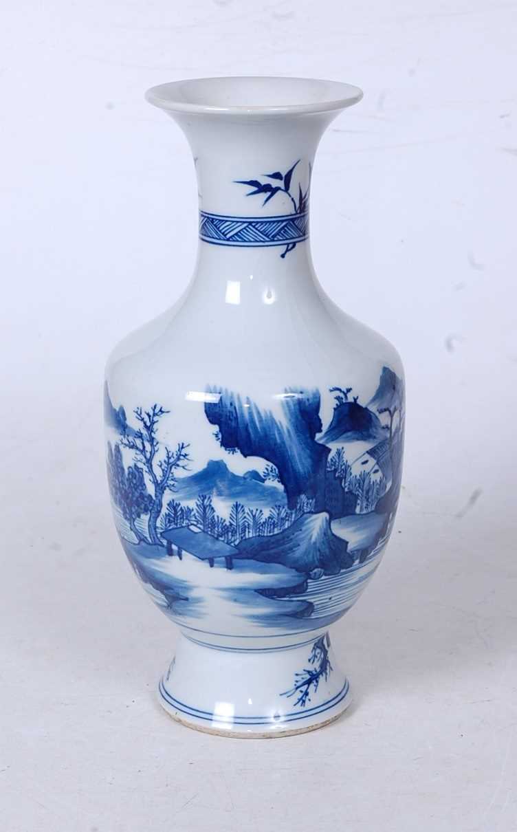A Chinese export blue and white vase, having a flared rim to a slender neck and bulbous lower