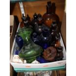 A collection of Victorian and later glass bottles to include blue and brown glass examples