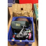 An MG 1000 fishing reel and several further fishing reels and a wicker tackle basket