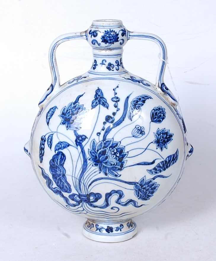 A reproduction Chinese blue and white moonflask, of slab-sided circular form, having twin handles,