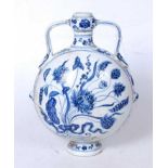 A reproduction Chinese blue and white moonflask, of slab-sided circular form, having twin handles,