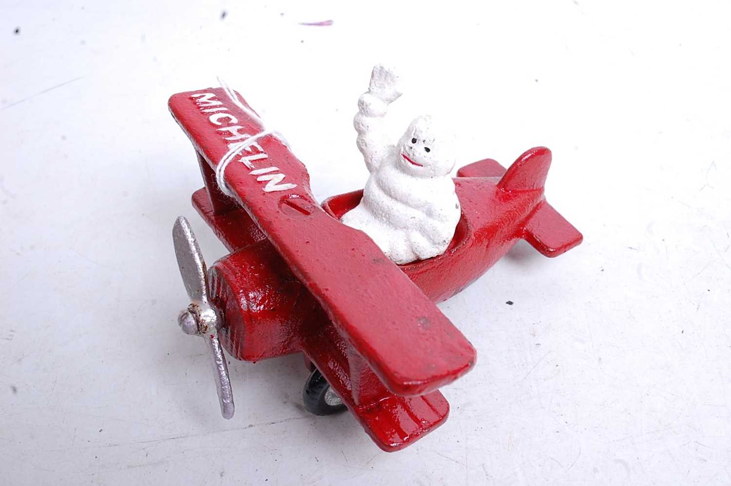 Two painted cast metal Michelin Man figures, one in a tractor, the other in an aeroplane - Image 2 of 3