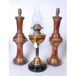 A late Victorian oil lamp having a brass font on a fluted column and domed base, 37cm, together with