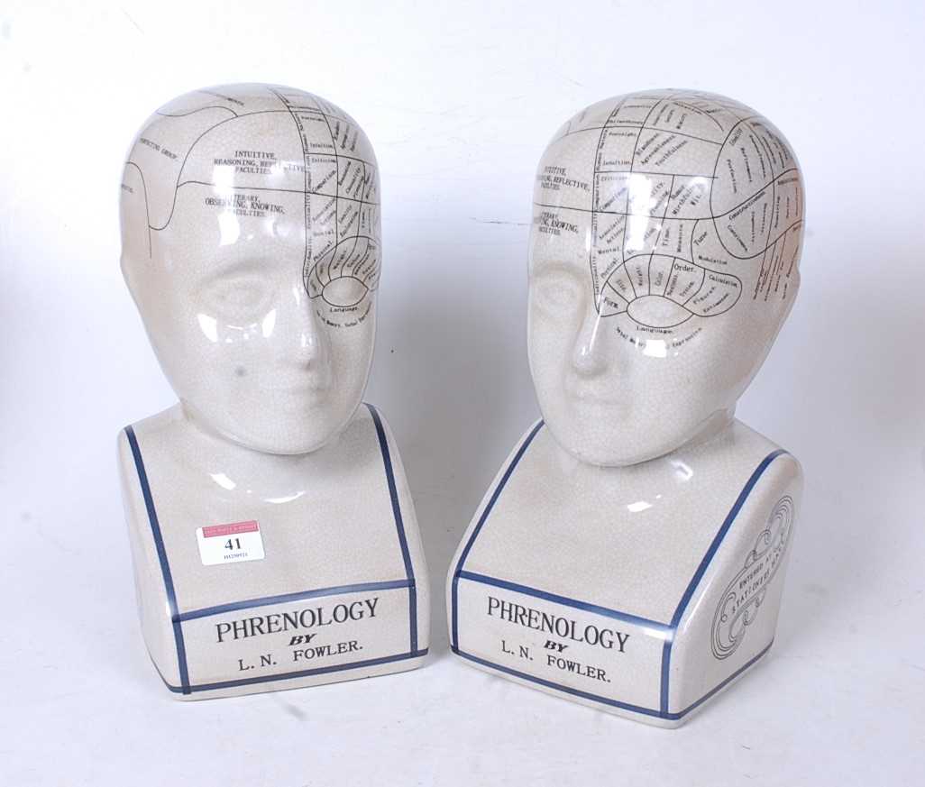 A pair of reproduction glazed ceramic phrenology busts, h.29cm