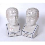 A pair of reproduction glazed ceramic phrenology busts, h.29cm