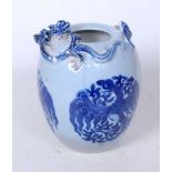 A Chinese vase, of ovoid form, on a blue ground, the rim relief decorated with kylin and prey, the