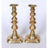 A pair of 19th century turned brass candlesticks, h.25cm