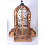 A large softwood and wirework birdcage, of domed form, containing two model birds, h.75cm